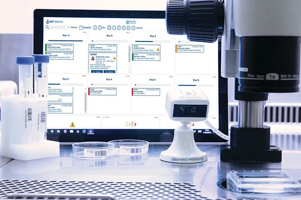 The Matcher scheduler on a monitor showing a week of patient activity, with a benchtop reader in front of it.
